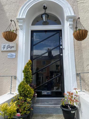 a door to a building with two baskets on it at The Maureen Suite in Llandudno