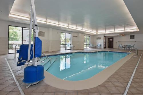 - une grande piscine d'eau bleue dans un bâtiment dans l'établissement SpringHill Suites by Marriott Charlotte / Concord Mills Speedway, à Concord