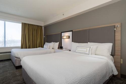 a hotel room with two beds and a window at SpringHill Suites by Marriott Charlotte / Concord Mills Speedway in Concord