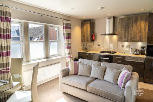 uma sala de estar com um sofá e uma cozinha em Burlington House em Oxford