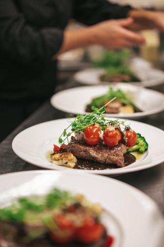 a row of plates of food on a table at Ringenäs Hotell & Konferens in Halmstad
