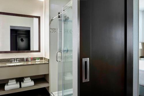 a bathroom with a glass shower and a sink at Seattle Marriott Redmond in Redmond