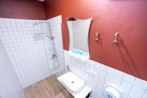 a bathroom with a toilet and a shower and a sink at Tiflis Hotel in Tbilisi City