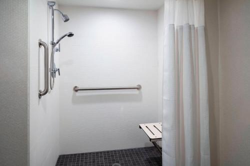 a bathroom with a shower with a shower curtain at Fairfield Inn & Suites by Marriott Providence Airport Warwick in Warwick