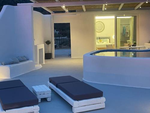 a room with two beds and a hot tub at Eye of Naxos in Naxos Chora