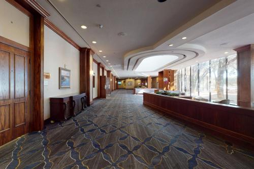 a hallway in a building with a large window at Austin Southpark Hotel in Austin