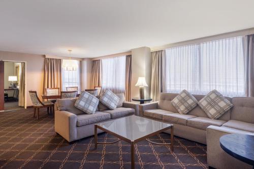 a living room with couches and a table at Austin Southpark Hotel in Austin