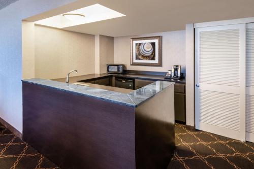 a hotel room with a kitchen with a counter at Austin Southpark Hotel in Austin