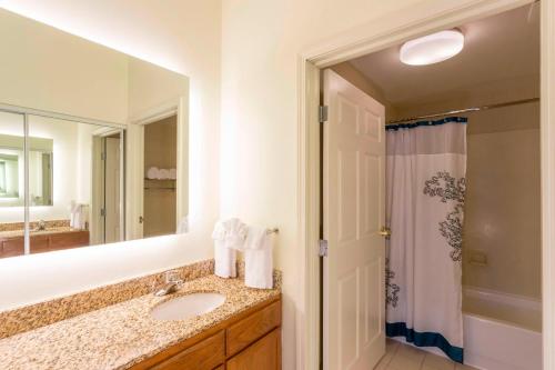 a bathroom with a sink and a large mirror at Residence Inn Louisville Northeast in Louisville