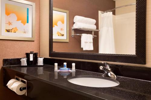 a bathroom with a sink and a mirror at Fairfield Inn & Suites by Marriott Dallas Plano in Plano