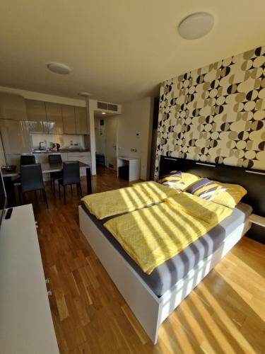 a bedroom with a large bed and a kitchen at Diamond Bled in Bled