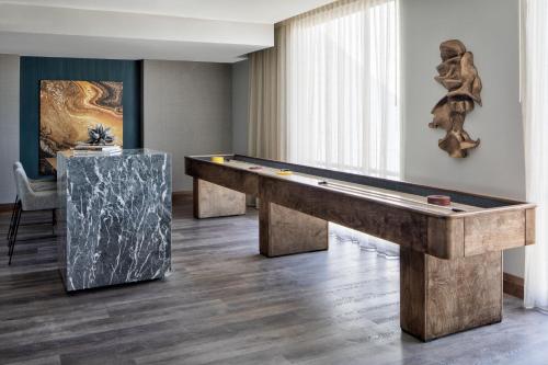 a pool table in a living room with ahibition at Odessa Marriott Hotel & Conference Center in Odessa