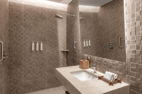 a bathroom with a sink and a shower at Barranquilla Marriott Hotel in Barranquilla