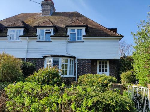 a house with white windows and a roof at April cottage in Winchelsea