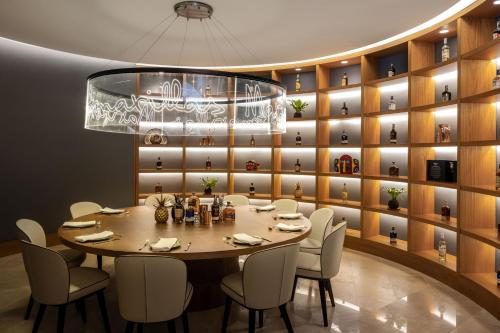 a dining room with a table and chairs and a chandelier at Barranquilla Marriott Hotel in Barranquilla