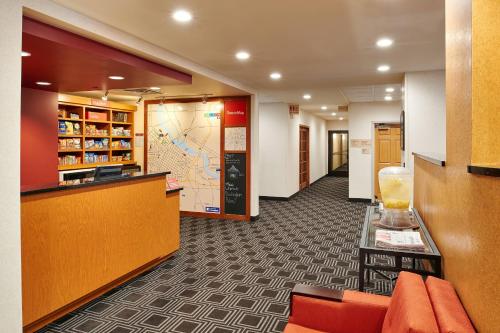 a lobby of a hotel with orange chairs and a counter at TownePlace Suites by Marriott Minneapolis Downtown/North Loop in Minneapolis