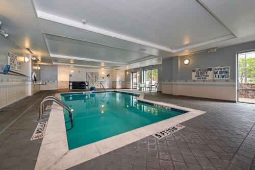 a large swimming pool in a large room with at SpringHill Suites Columbia Downtown The Vista in Columbia