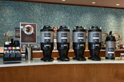 a row of coffee cups sitting on a counter at SpringHill Suites Columbia Downtown The Vista in Columbia