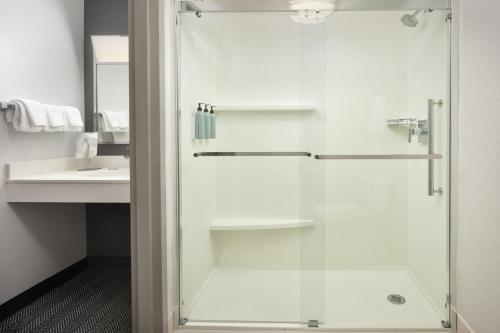 a bathroom with a shower with a glass door at Courtyard Boulder Longmont in Longmont