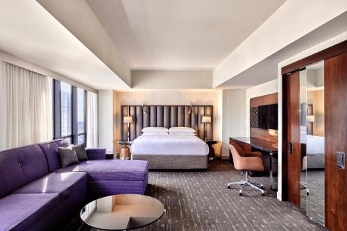 a hotel room with a bed and a couch at Sheraton Grand Los Angeles in Los Angeles
