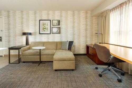 a living room with a couch and a desk at Residence Inn by Marriott North Little Rock in North Little Rock