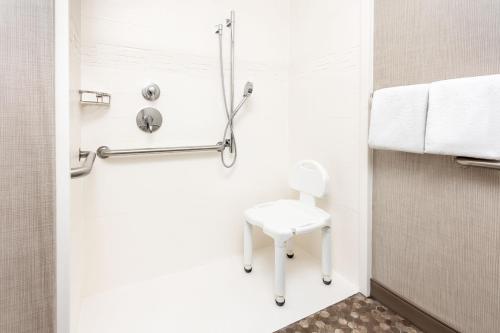 a small bathroom with a white toilet and a stool at Residence Inn by Marriott North Little Rock in North Little Rock