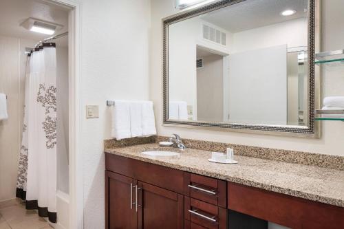 a bathroom with a sink and a mirror at Residence Inn Pleasant Hill Concord in Pleasant Hill