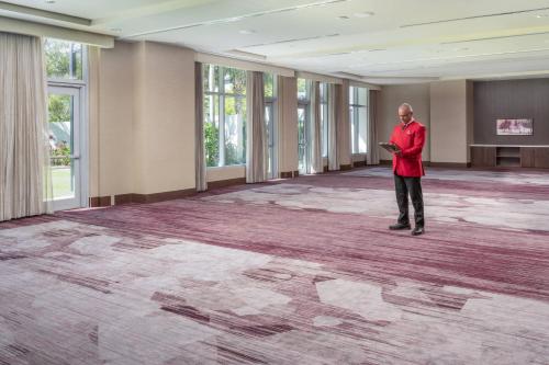 a man standing in the middle of a large room at Courtyard by Marriott Miami Airport in Miami
