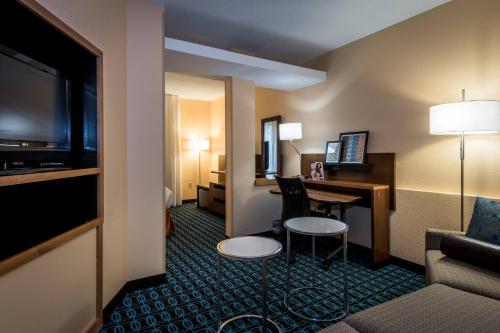 a hotel room with a desk and a room at Fairfield Inn & Suites Savannah I-95 South in Savannah
