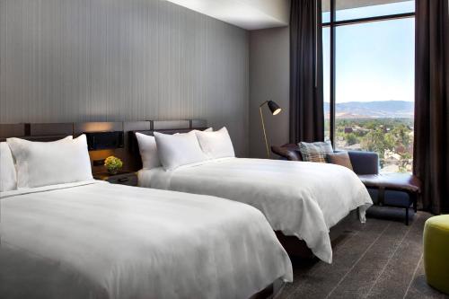 A bed or beds in a room at Renaissance Reno Downtown Hotel & Spa