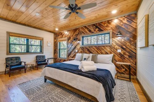 a bedroom with a bed and a wooden ceiling at Serene Broken Bow Cabin with Hot Tub and Fire Pit! in Broken Bow