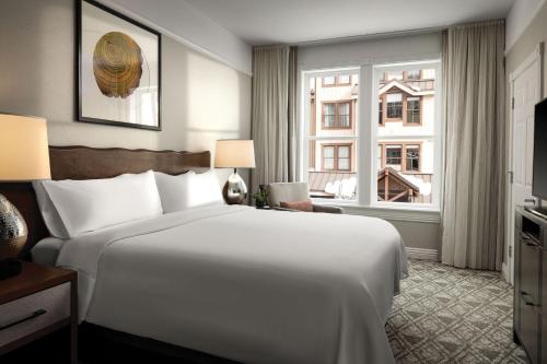 a hotel room with a large bed and a window at Marriott's Summit Watch in Park City