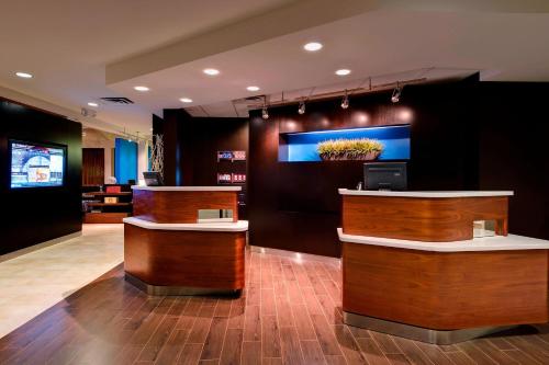 a salon with wooden counters and a tv on the wall at Heritage Place Houston Brookhollow in Houston
