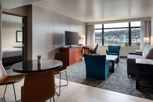 a hotel room with a bed and a living room at Courtyard Seattle Downtown/Lake Union in Seattle