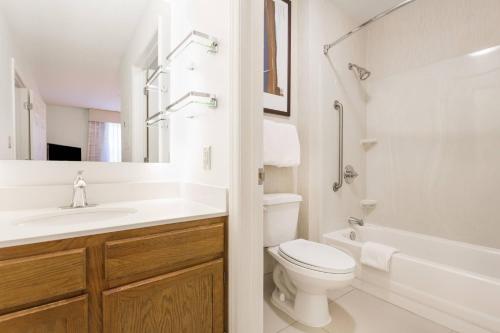 a white bathroom with a toilet and a sink at Residence Inn by Marriott Rocky Mount in Rocky Mount