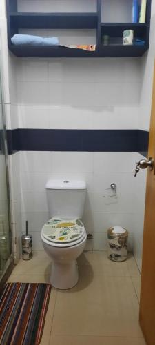 a bathroom with a white toilet in a room at My Flat in Praia