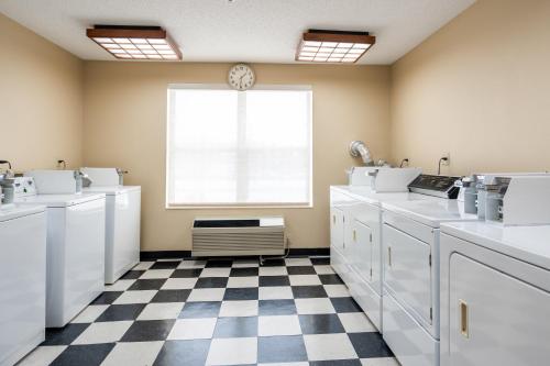 a kitchen with white appliances and a checkered floor at TownePlace Suites Rochester in Rochester
