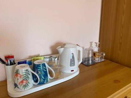 a kitchen counter with a coffee maker on a shelf at Creag Dubh Bed & Breakfast in Kyle of Lochalsh