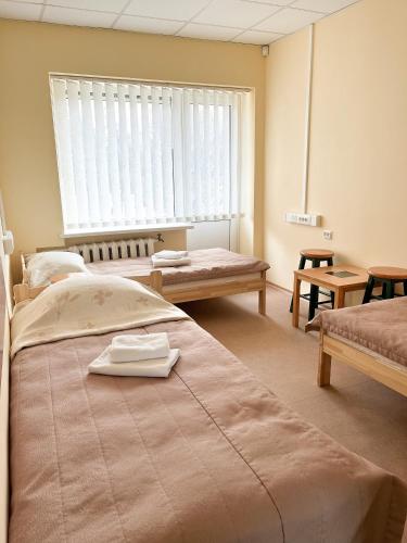 a hospital room with two beds and a window at Apgyvendinimo įstaiga KORNEALITA in Zarasai