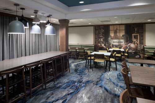 a restaurant with tables and chairs and a bar at Fairfield Inn & Suites South Bend at Notre Dame in South Bend