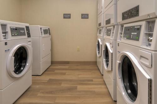 a laundry room with three washing machines and a floor at Residence Inn by Marriott Pigeon Forge in Pigeon Forge