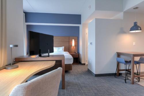 a hotel room with a bed and a desk at Residence Inn by Marriott Pigeon Forge in Pigeon Forge