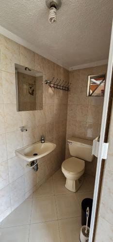 a bathroom with a sink and a toilet at Casa Campestre Las Margaritas 