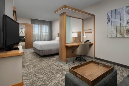 a hotel room with a bed and a desk at SpringHill Suites by Marriott Tuscaloosa in Tuscaloosa