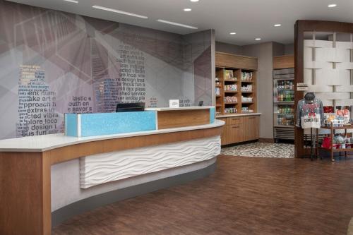 a lobby of a store with a checkout counter at SpringHill Suites by Marriott Tuscaloosa in Tuscaloosa