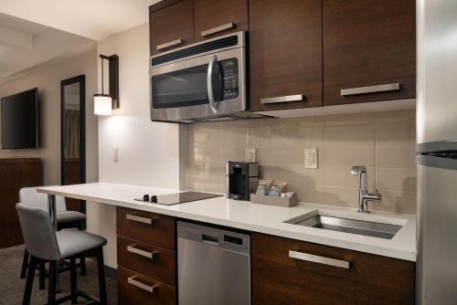 a kitchen with a sink and a microwave at Residence Inn by Marriott New York Manhattan/ Midtown Eastside in New York