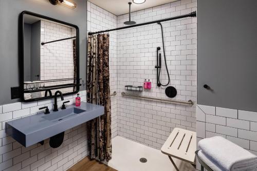 a bathroom with a sink and a shower at Moxy Minneapolis Downtown in Minneapolis