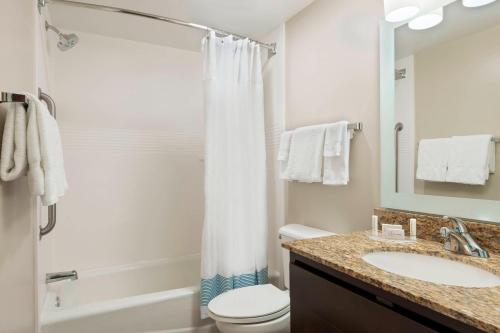 a bathroom with a sink and a toilet and a shower at TownePlace Suites Savannah Midtown in Savannah