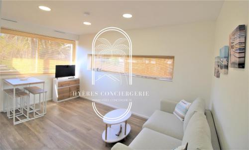un salon avec un canapé et une table dans l'établissement Le Berriau-Studio-CLiM/PK/WiFi/Plage Privée/Hyères, à Hyères