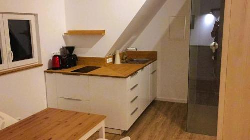 a small kitchen with a sink and a shower at Top in Rüdesheim am Rhein